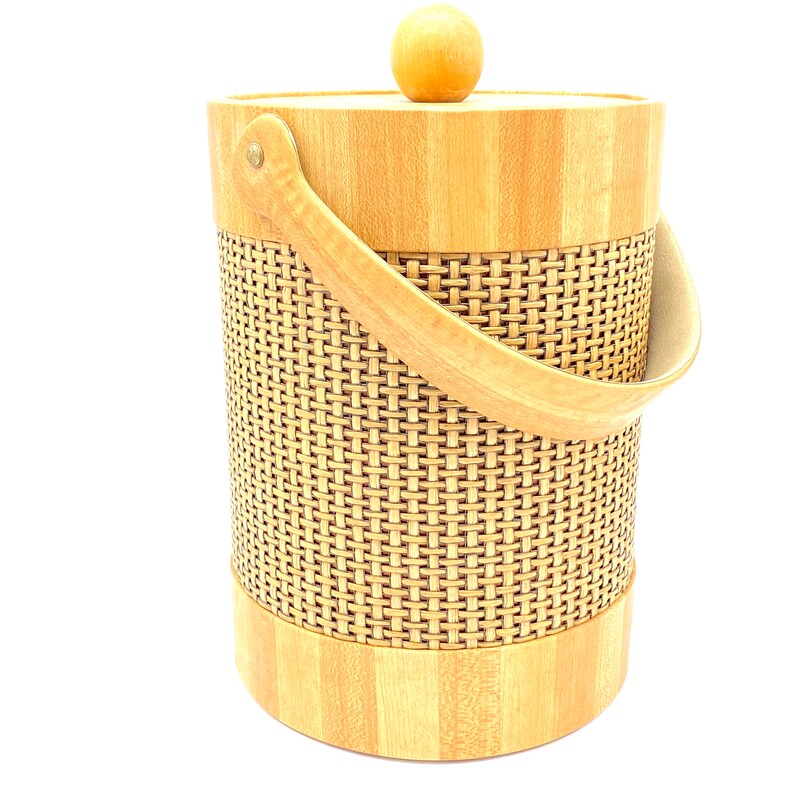 May include: A woven wicker and wood ice bucket with a wooden lid and handle. The bucket is light brown and has a woven pattern.