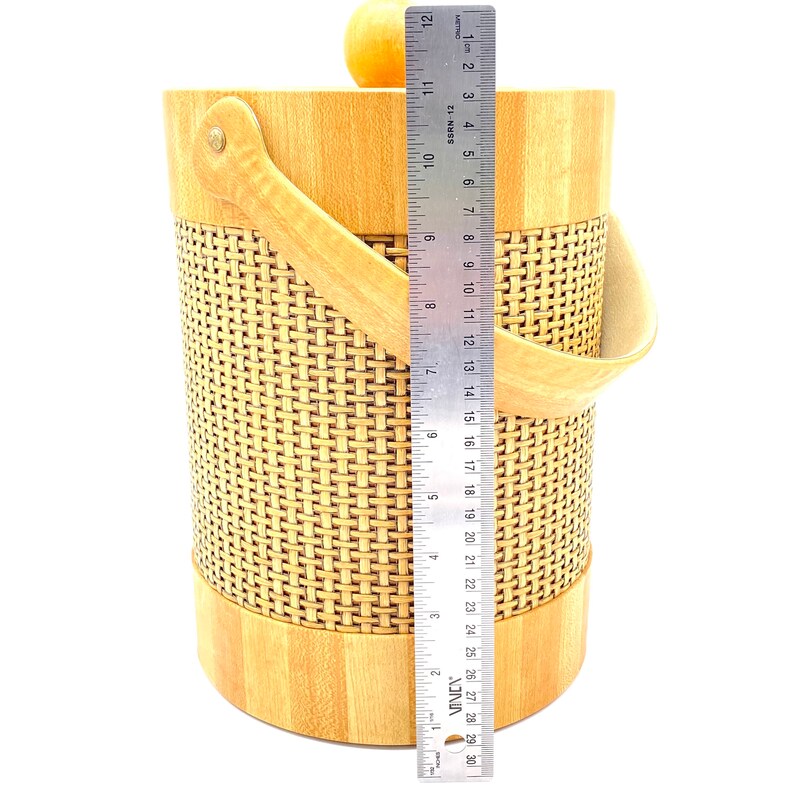 May include: A wooden ice bucket with a woven design and a leather handle. The bucket is 12 inches tall.