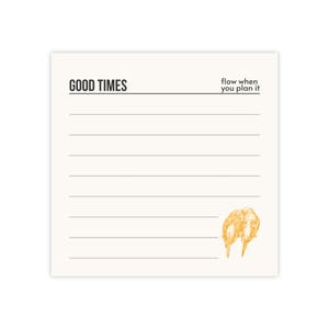 May include: A square, off-white notepad with the words "GOOD TIMES" and "flow when you plan it" printed in black. The notepad has horizontal lines for writing and a gold illustration of two objects. Stationery.