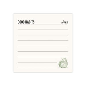 May include: A cream-colored notepad with the words "GOOD HABITS" at the top, and the phrase "have rhythm" in the upper right corner. The notepad has horizontal lines for writing and a small green owl illustration at the bottom right.