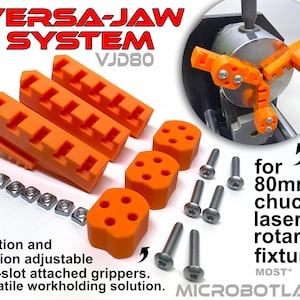 May include: An orange Versa-Jaw System VJD80 with multiple components, including t-slot grippers, nuts, and screws. The system is designed for 80mm chuck laser rotary fixtures. Text on the image reads "Position and rotation adjustable" and "Versatile workholding solution."