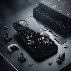 May include: A black smartphone case featuring white and orange graphic illustrations of gaming controllers, rockets, and text including Time To Play, Still Win, and Game No Sleep Drink Tipsy, alongside geometric shapes and a matching black gift box.