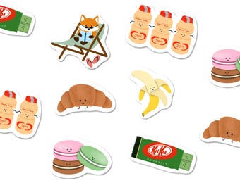 May include: A collection of die-cut stickers featuring various illustrations including a fox reading in a lounge chair, yogurt drink bottles, croissants, bananas, macarons, and KitKat bars, all designed with simple, friendly facial expressions.