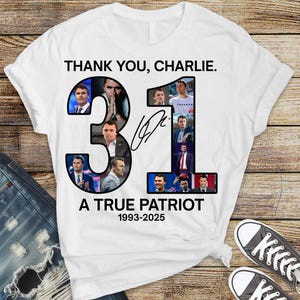 May include: White t-shirt with the text "THANK YOU, CHARLIE." and the number "31" filled with images. Below the number is the text "A TRUE PATRIOT 1993-2025" and a signature. The shirt is paired with blue jeans and black and white sneakers.