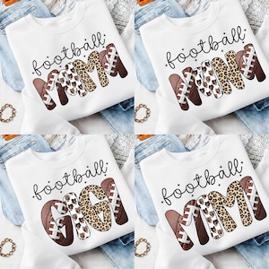 May include: Four white sweatshirts with the word "football" in black script. The word "MAMA" is in a football design with brown, white, and leopard print. One sweatshirt says "GIGI" instead of "MAMA".