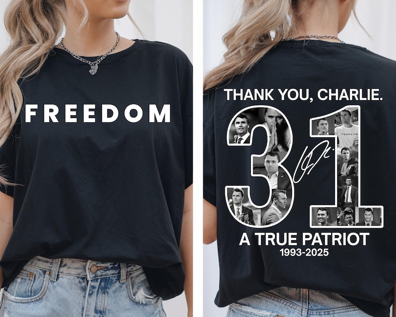 May include: Black t-shirt with the word "FREEDOM" in white block letters on the front. The back of the shirt features the text "THANK YOU, CHARLIE." with the number "31" and the words "A TRUE PATRIOT 1993-2025".