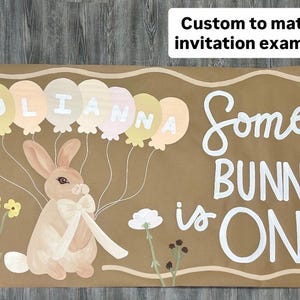 May include: A rectangular brown banner featuring a painted rabbit with a white bow, surrounded by pastel balloons spelling JULIANNA and the white text Some BUNNY is ONE. A white box in the corner contains the text Custom to match invitation example.