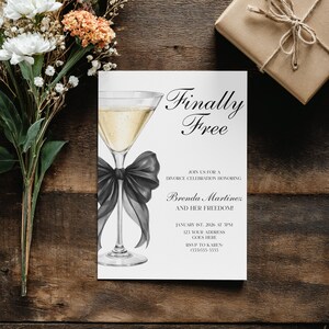 May include: A white invitation card with the text "Finally Free" and a champagne glass illustration with a black bow. The card is for a divorce celebration honoring Brenda Martinez. A gift box and flowers are also in the image.