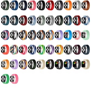 Può includere: Una collezione di cinturini per smartwatch in vari colori e fantasie. I cinturini sono esposti con i quadranti degli orologi che mostrano l'ora. I colori includono verde, blu, rosso, arancione e viola. I cinturini sono realizzati in materiale tessuto.