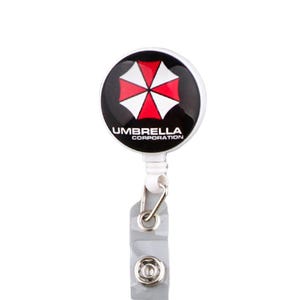 Umbrella Corporation badge reel with clip and clear strap, round logo retractable holder for work ID cards.
