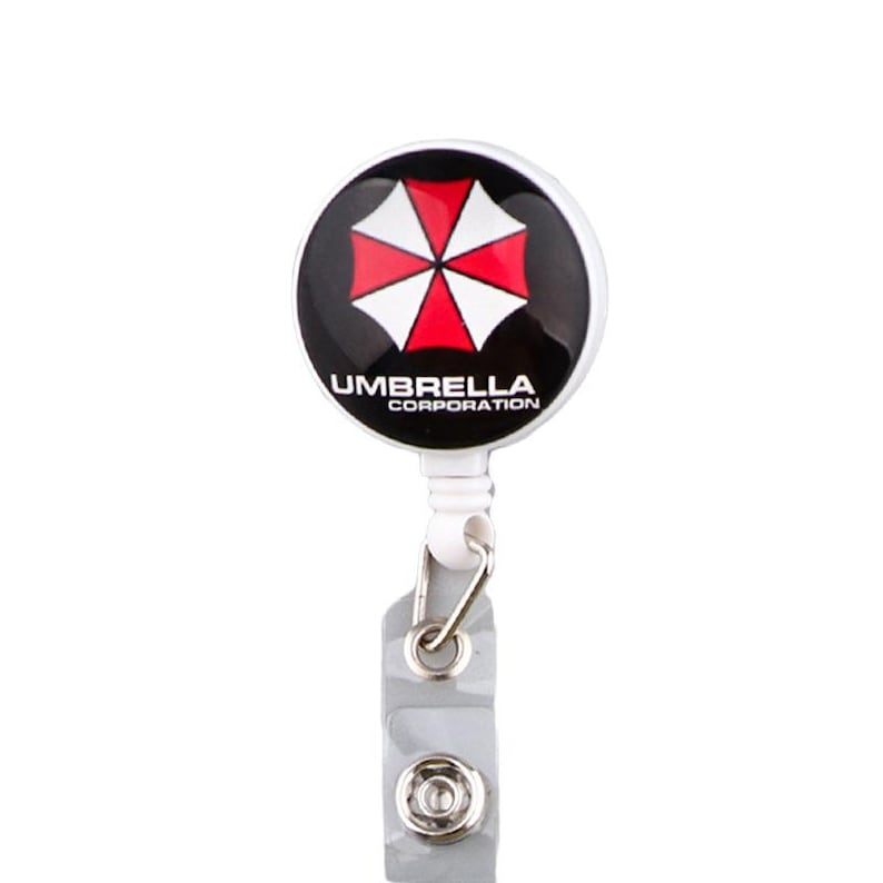 Umbrella Corporation badge reel with clip and clear strap, round logo retractable holder for work ID cards.