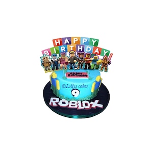 Roblox cake topper featuring characters and happy birthday letters on blue birthday cake