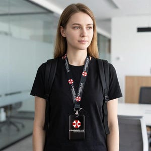 Woman wearing Umbrella Corporation lanyard with black ID holder, keycard badge case for office and campus use.