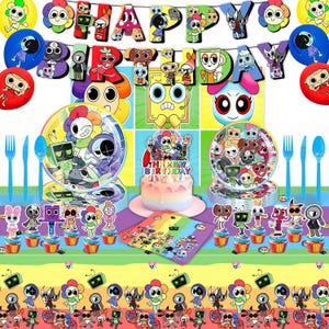Op de afbeelding: Een kleurrijke verjaardagsfeestset met borden, bekers, bestek, ballonnen en een taart. De decoraties omvatten een banner met de tekst "HAPPY BIRTHAY" en cupcake toppers. Het thema omvat cartoonkarakters in verschillende kleuren.