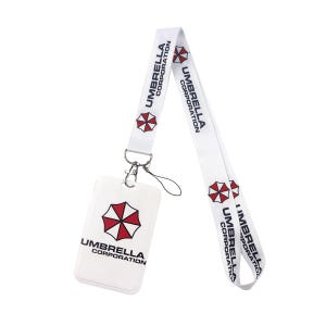 White vertical ID badge holder with Umbrella Corporation lanyard, hard card case for work and conventions.