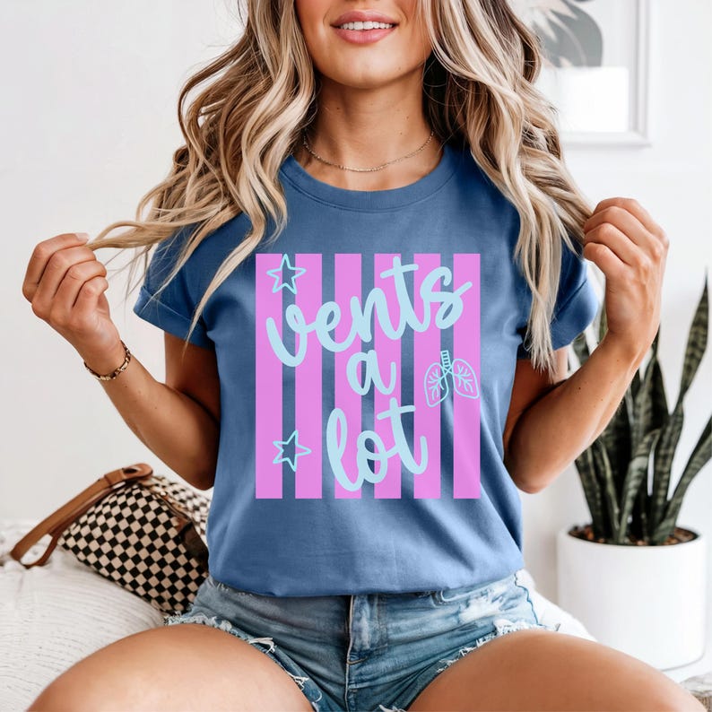 Woman sitting wearing funny blue respiratory therapy shirt that says, "Vents a Lot".