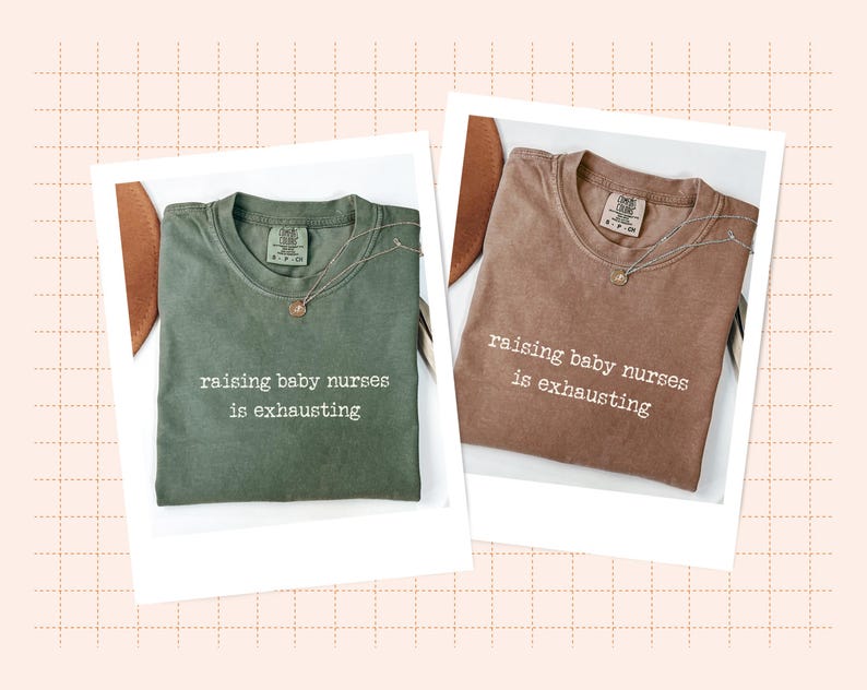 May include: Two t-shirts, one olive green and one brown, each with the phrase "raising baby nurses is exhausting" printed in white. Each shirt is paired with a delicate necklace. The shirts are displayed on a white background.