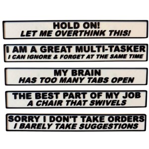 May include: A collection of five rectangular signs with black borders and white backgrounds. Each sign features black text with humorous statements such as "HOLD ON! LET ME OVERTHINK THIS!" and "I AM A GREAT MULTI-TASKER".