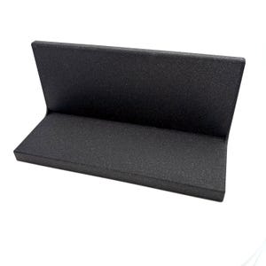 May include: A black L-shaped display stand with a textured, matte finish. The object features a horizontal base platform connected to a vertical back panel, forming a right angle. The surface has a consistent dark, granular appearance throughout.