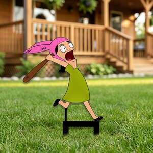 May include: A flat, two-dimensional yard sign featuring a cartoon character with a pink bunny-ear hat, a green dress, and black shoes, depicted in a running pose while holding a brown baseball bat, mounted on a black metal H-frame stake.