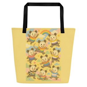 May include: A yellow tote bag with black handles. The bag features a repeating pattern of cartoon opossums wearing rainbow-coloured shirts, set against a backdrop of clouds, stars, and a rainbow. The bag is designed for carrying items.