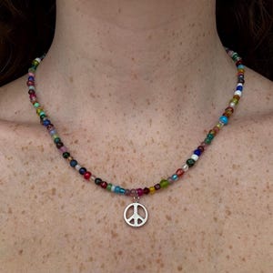 necklace made of a variety of multicolor beads with a peace sign charm