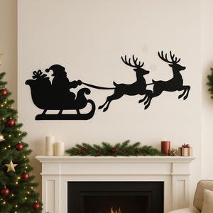May include: A black silhouette of Santa Claus in a sleigh pulled by two reindeer, mounted on a white wall. The Christmas-themed wall decor is above a fireplace decorated with candles and greenery. A Christmas tree is on the left.
