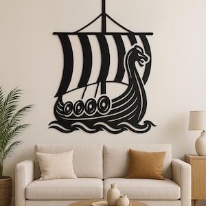 May include: Black metal wall art of a Viking ship with a striped sail. The ship has a dragon head at the bow. It is mounted above a sofa in a living room. The artwork is a decorative piece, suitable for interior decor.