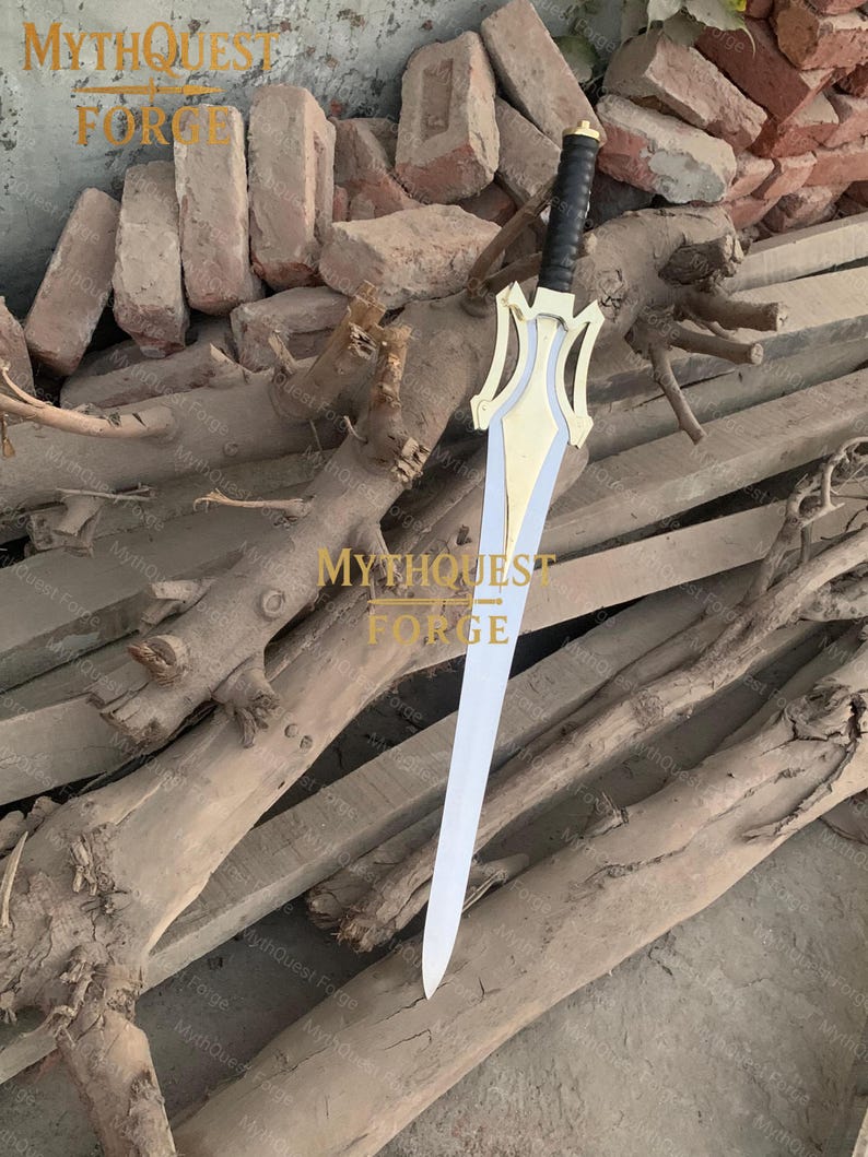 May include: A decorative sword with a gold-colored hilt and a silver blade. The hilt has a black grip and a stylized design. The sword is displayed on a wooden surface. The text "MYTHQUEST FORGE" is visible in the image.