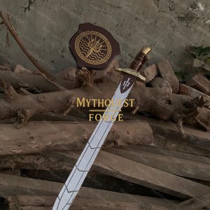 May include: A silver and white sword with a brown handle and gold accents, displayed with a brown shield featuring a gold emblem. The sword has a detailed blade design and is set against a backdrop of wooden logs. The text "MYTHQUEST FORGE" is visible.