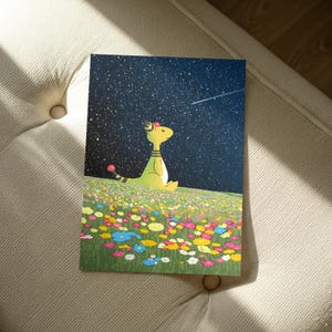May include: A colorful art print featuring a cartoon-style creature with a yellow body, sitting in a field of flowers under a starry night sky. The creature has a red and black striped tail and a small hat. The flowers are in various colors.