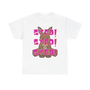 May include: White t-shirt featuring a cartoon donkey with the text "SYAD!" in pink, repeated three times. The donkey is brown with a smiling expression. The design is centered on the shirt.