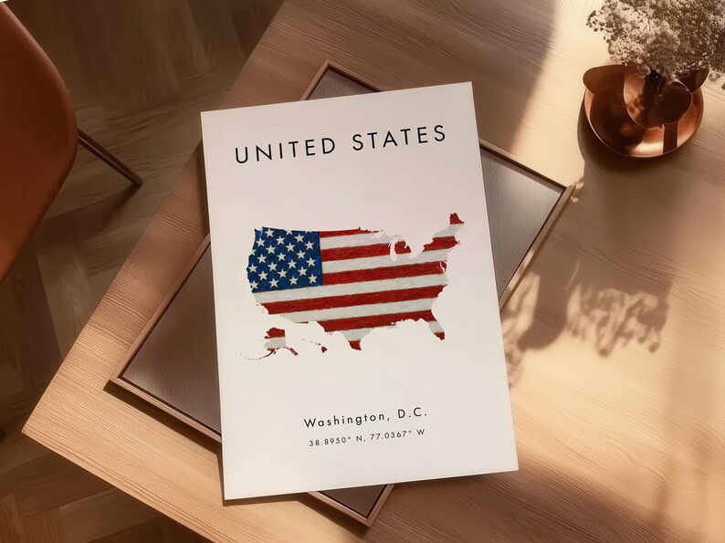 Może przedstawiać: Biały nadruk przedstawiający mapę Stan&oacute;w Zjednoczonych z motywem amerykańskiej flagi. U g&oacute;ry znajduje się napis &bdquo;UNITED STATES&rdquo;, a na dole &bdquo;Washington, D.C.&rdquo; ze wsp&oacute;łrzędnymi. Nadruk znajduje się na drewnianym stole.