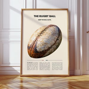 Könnte beinhalten: Gerahmter Druck mit einer Illustration eines Rugbyballs. Das Kunstwerk enthält den Text "THE RUGBY BALL" und "KEEP THE BALL ALIVE". Der Rugbyball ist braun und weiß, vor einem cremefarbenen Hintergrund. Der Rahmen ist hellbraun.