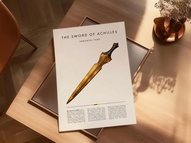 Peut inclure: Impression intitul&eacute;e "The Sword of Achilles" avec une illustration d'&eacute;p&eacute;e dor&eacute;e et le texte "IMMORTAL FAME". L'impression pr&eacute;sente un bloc de texte en bas. L'image est sur une table en bois.