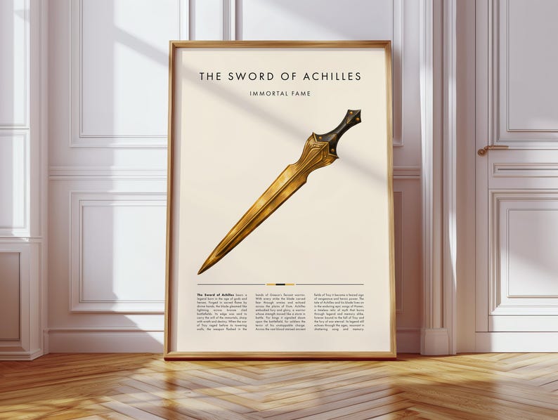 Peut inclure: Impression encadr&eacute;e d'une &eacute;p&eacute;e dor&eacute;e avec une poign&eacute;e noire, intitul&eacute;e "THE SWORD OF ACHILLES". L'&oelig;uvre est pos&eacute;e sur un fond cr&egrave;me avec du texte en dessous. Le cadre est de couleur marron clair.