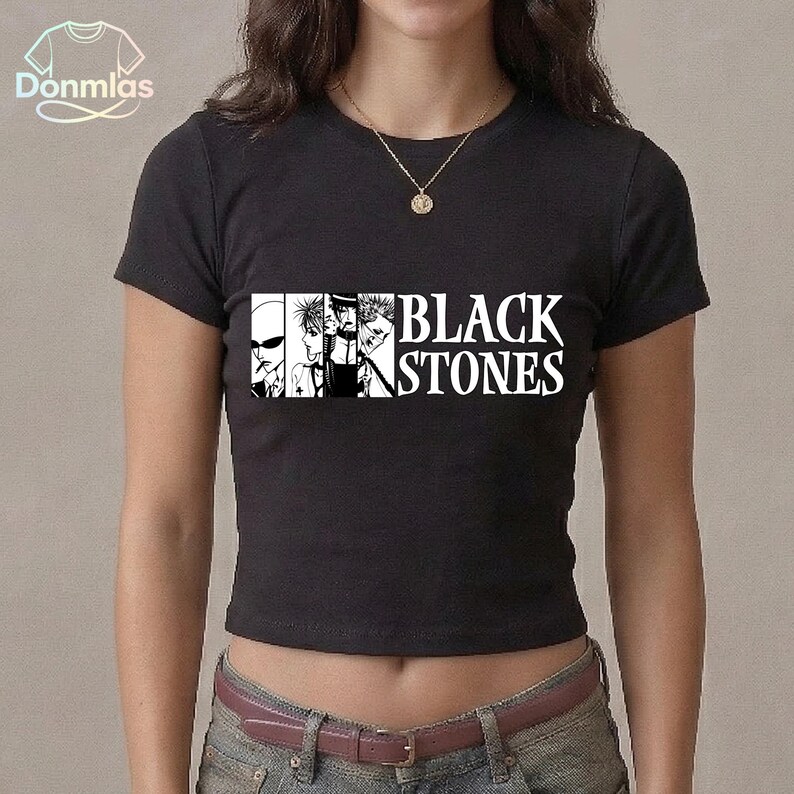 May include: Black crew neck t-shirt with a graphic of stylized faces and the text "BLACK STONES" in white. The shirt is a cropped style and is made of a dark fabric.