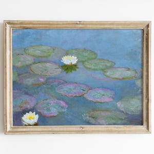 May include: A framed painting of water lilies in a pond. The artwork features a blue background with green lily pads and white flowers. The frame is a light gold color, adding a classic touch to the art.