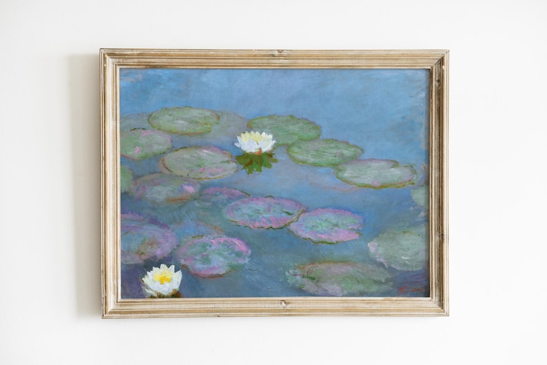 May include: A framed painting of water lilies in a pond. The artwork features a blue background with green lily pads and white flowers. The frame is a light gold color, adding a classic touch to the art.