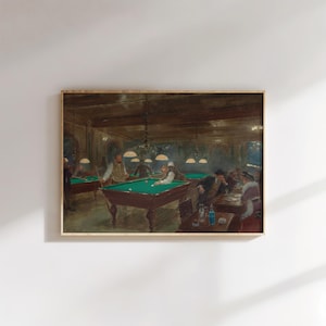 May include: A framed print of a vintage painting depicting a billiards room. Several men are gathered around green-felted pool tables, illuminated by overhead lamps. The scene is set in a dimly lit, wood-paneled room, evoking a classic, historical ambiance.