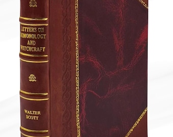 Op de afbeelding: Een hardcover boek getiteld "Letters on Demonology and Witchcraft" van Walter Scott. Het boek heeft een bordeauxrode leren kaft met gouden accenten en een rood lint als bladwijzer. De rug is donkerder bordeaux met gouden letters en decoratieve elementen.