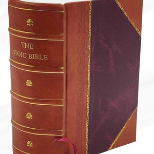 May include: A hardcover book titled "THE STOIC BIBLE" with a brown leather cover. The spine features gold accents and decorative elements. The book has a burgundy bookmark and a patterned cover design.