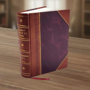 May include: A hardcover book titled "Stephens' Book of the Farm, Vol. I" with a burgundy cover and spine. The spine is a lighter brown with gold lettering and decorative accents. A red ribbon bookmark is visible.