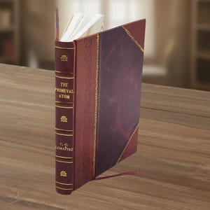 May include: A hardcover book titled "The Primeval Atom" by C.G. Lema&icirc;tre. The book has a burgundy leather cover with gold accents and a decorative spine. The pages are white, and a red ribbon bookmark is visible.