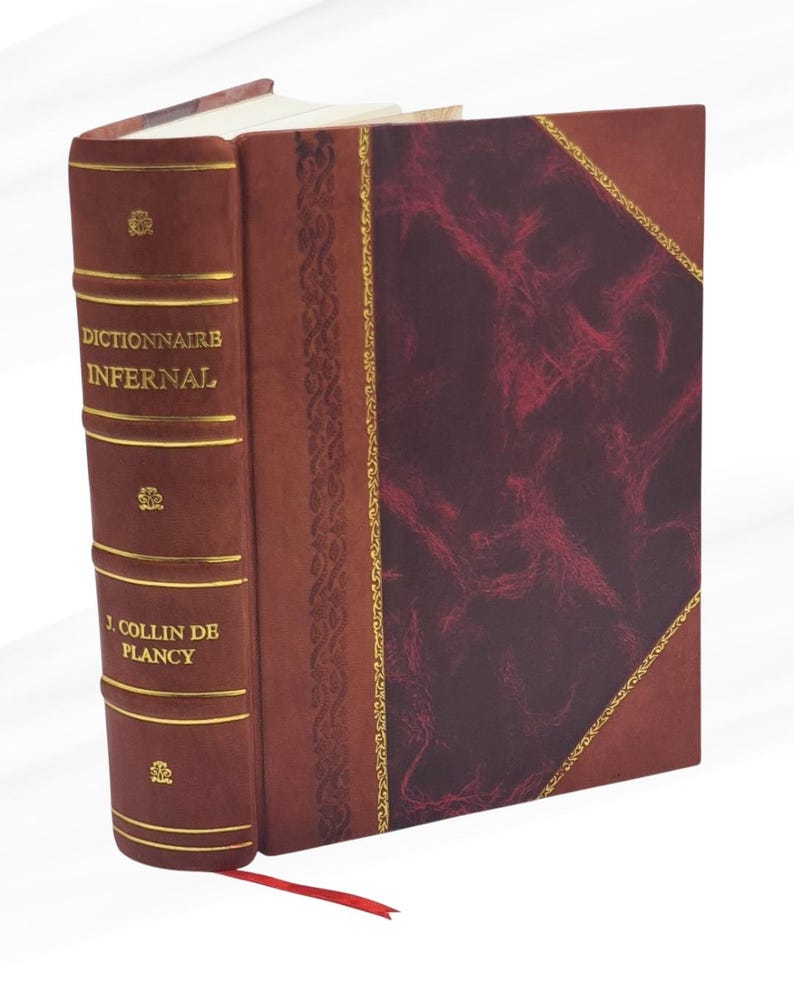 May include: A hardcover book titled "Dictionnaire Infernal" by J. Collin de Plancy. The book has a burgundy cover with gold accents and a red ribbon bookmark. The cover features a marbled design and gold trim.