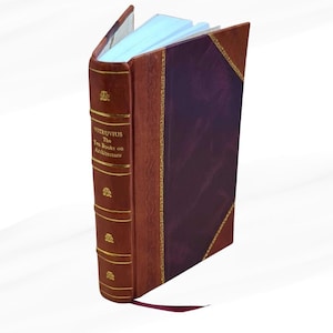 May include: An open book titled "Vitruvius The Ten Books on Architecture." The book has a brown leather cover with gold accents and a burgundy spine. A burgundy ribbon bookmark is visible. The pages are light blue.
