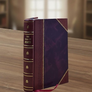 May include: A hardback book titled The Iliad of Homer with a deep burgundy spine featuring gold horizontal lines and decorative floral emblems. The front cover is a dark purple with a textured finish, bordered by intricate gold filigree patterns.