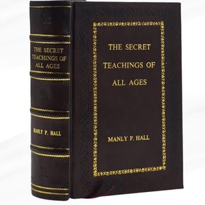 May include: A hardcover book titled "The Secret Teachings of All Ages" by Manly P. Hall. The book has a dark brown cover with gold lettering and decorative accents. The spine also features gold lettering.