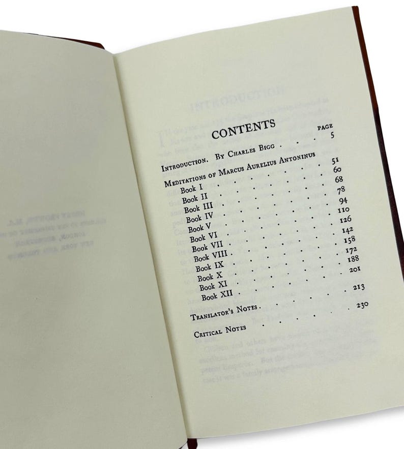 May include: An open book with a brown cover, displaying the contents page. The text includes "CONTENTS," "INTRODUCTION," and "MEDITATIONS OF MARCUS AURELIUS ANTONINUS." Page numbers are listed next to each chapter. The pages are off-white.