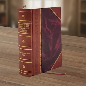 May include: A hardcover book titled "History of the Carlock Family and Adventures of Pioneer Americans." The book has a burgundy leather cover with gold accents and a decorative spine. A red ribbon bookmark extends from the book.